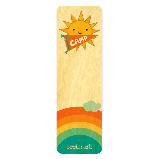 Wooden bookmark with cute, happy sun holding a banner that reads 'Camp'. Rainbow and cloud illustration at bottom.