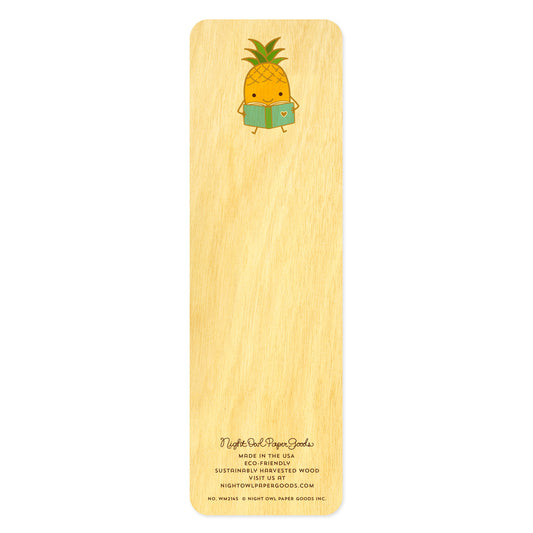 Back of wooden bookmark with a cute pineapple sitting down and reading a book 