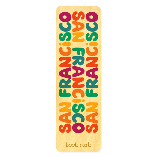 Wooden bookmark that features colorful text in a rainbow of colors that reads San Francisco three times