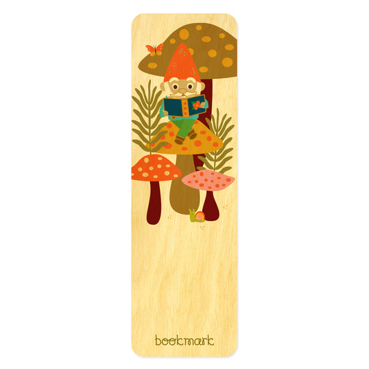 Wooden bookmark with an illustration of a gnome sitting on a mushroom reading 